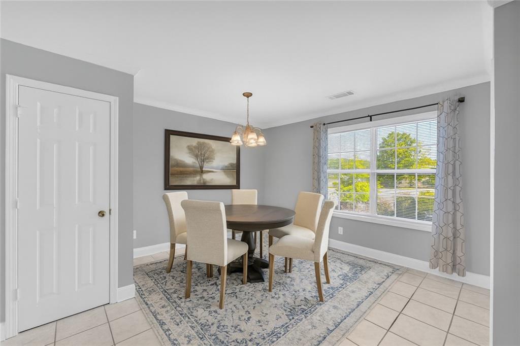 105 Whitehead Road, Unit 17 Athens, GA 30606 - Photo 13 of 38 a dining room with furniture a rug and a chandelier