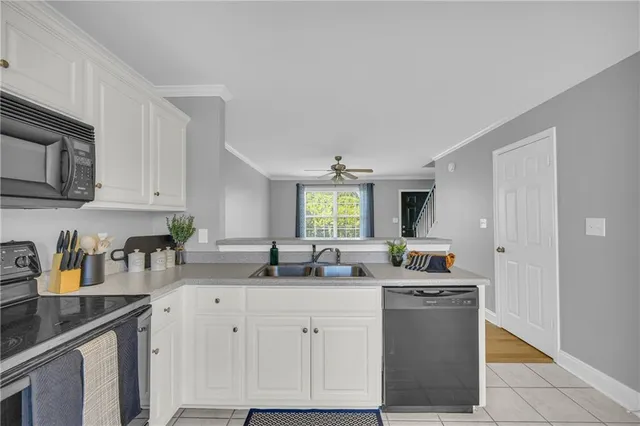 a kitchen with stainless steel appliances granite countertop a refrigerator sink and cabinets