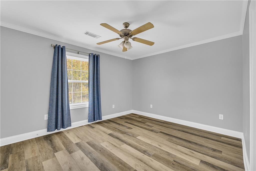 105 Whitehead Road, Unit 17 Athens, GA 30606 - Photo 29 of 38 wooden floor in an empty room with a window