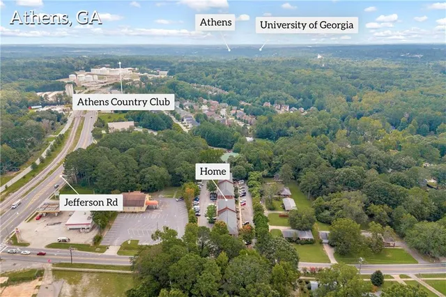 an aerial view of a house with yard swimming pool and outdoor seating