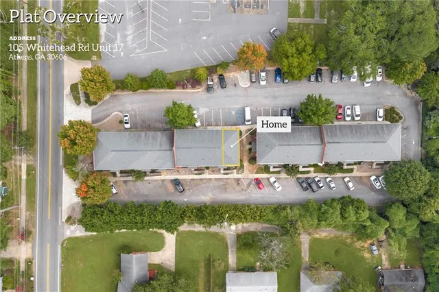 an aerial view of a house with a yard basket ball court and outdoor seating