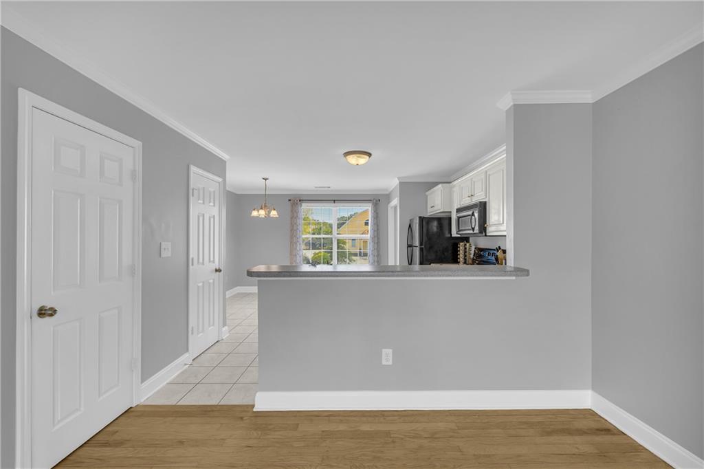 105 Whitehead Road, Unit 17 Athens, GA 30606 - Photo 10 of 38 a living room with stainless steel appliances wooden floor and large window