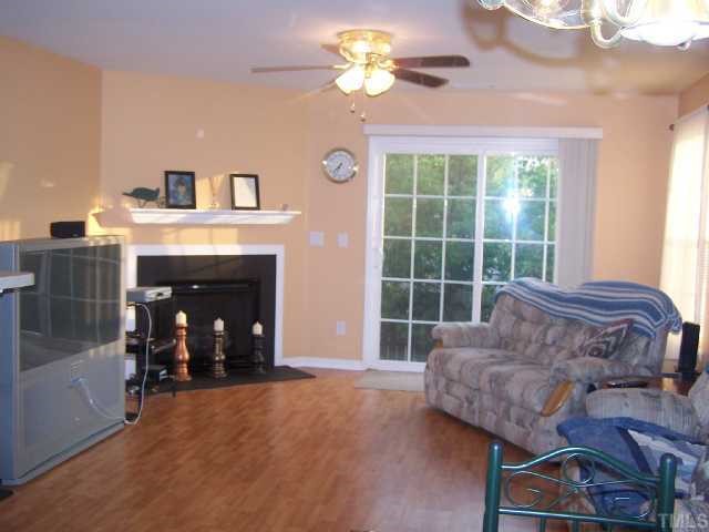 5816 Bryanstone Place Raleigh, NC 27610 - Photo 2 of 8 a living room with furniture and a fireplace
