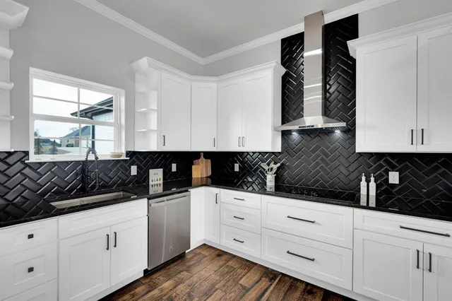 a kitchen with white cabinets and sink