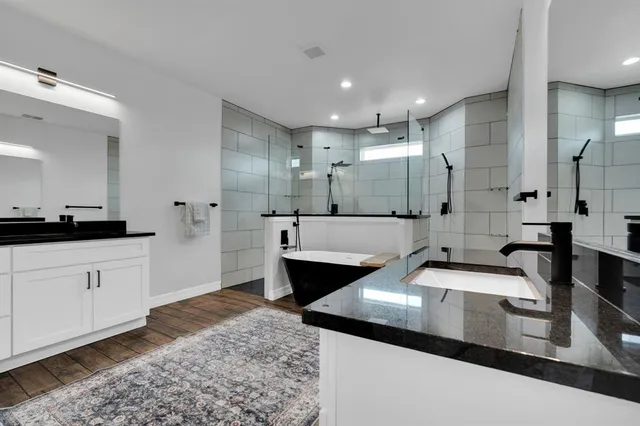 a large bathroom with a double vanity sink and mirror