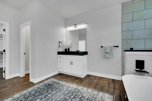 a room with a bed and a television