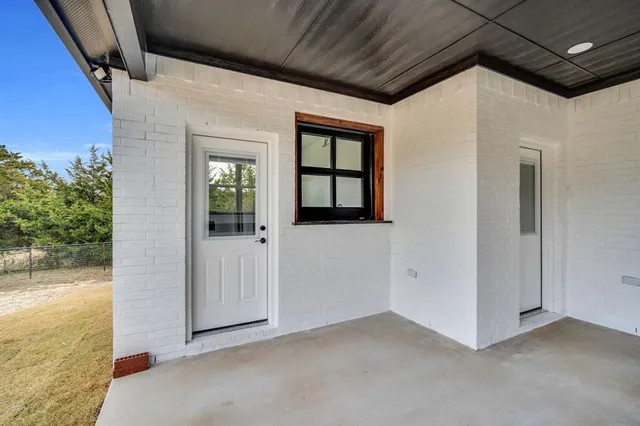 a view of an empty room with windows