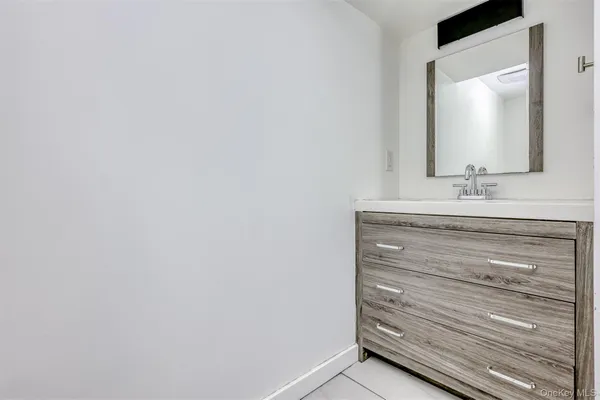 a bathroom with a vanity and a mirror