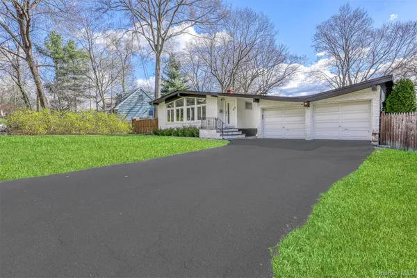 a view of a house with a yard and garage