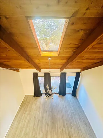 a view of a room with wooden floor