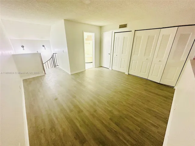 a view of a room with wooden floor and a sink