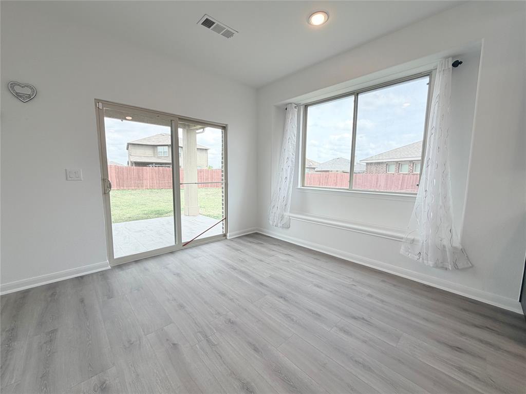 3310 Tanseyleaf Drive Forney, TX 75126 - Photo 12 of 33 an empty room with wooden floor and windows