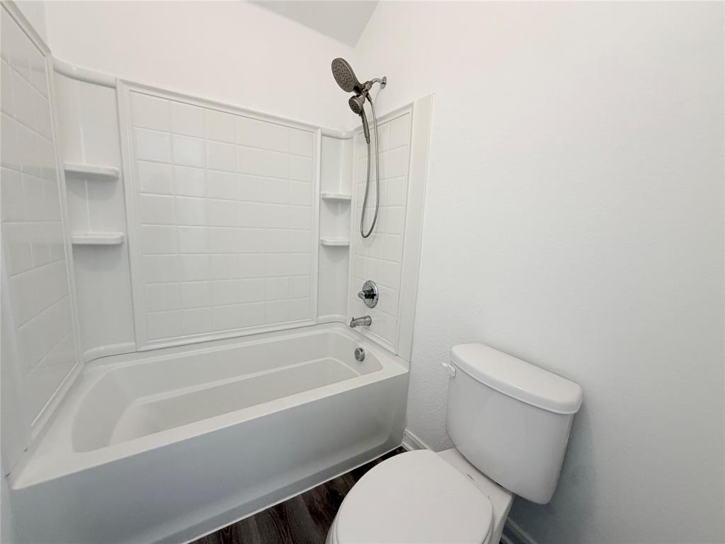 3310 Tanseyleaf Drive Forney, TX 75126 - Photo 15 of 33 a bathroom with a toilet and a bath tub