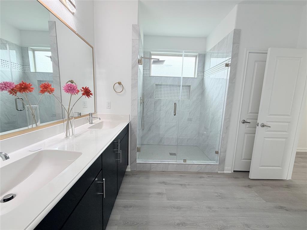 3310 Tanseyleaf Drive Forney, TX 75126 - Photo 21 of 33 a bathroom with a shower sink and a mirror
