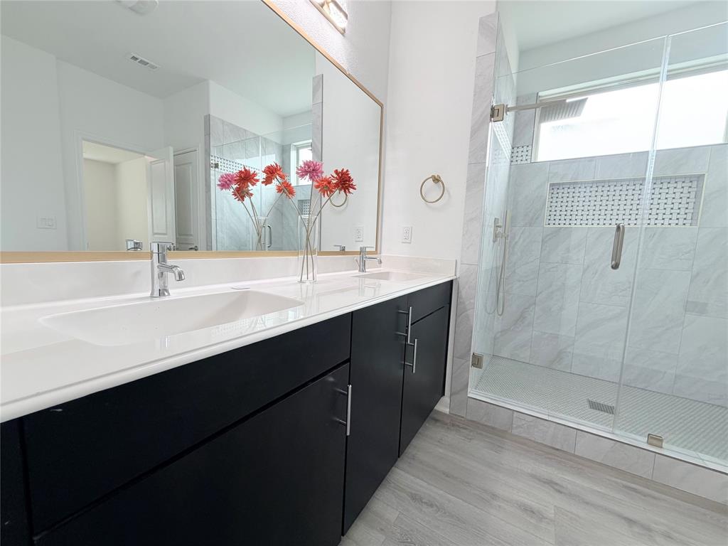 3310 Tanseyleaf Drive Forney, TX 75126 - Photo 22 of 33 a bathroom with a sink and a mirror