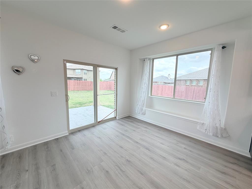 3310 Tanseyleaf Drive Forney, TX 75126 - Photo 27 of 33 an empty room with wooden floor and windows
