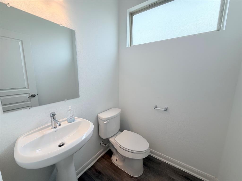 3310 Tanseyleaf Drive Forney, TX 75126 - Photo 28 of 33 a white toilet sitting next to a bathroom sink