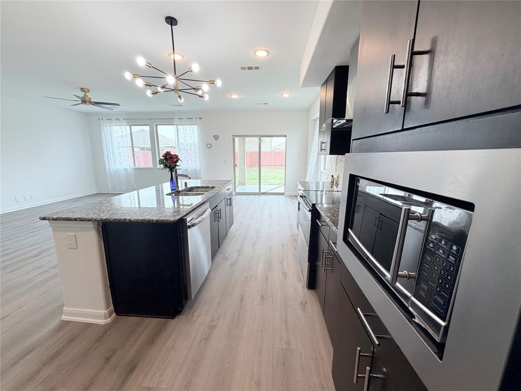 3310 Tanseyleaf Drive Forney, TX 75126 - Photo 5 of 33 a kitchen with sink and refrigerator