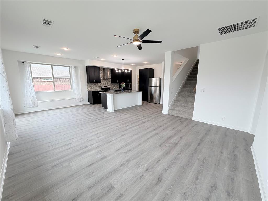 3310 Tanseyleaf Drive Forney, TX 75126 - Photo 9 of 33 a view of a living room hardwood floor and a ceiling fan