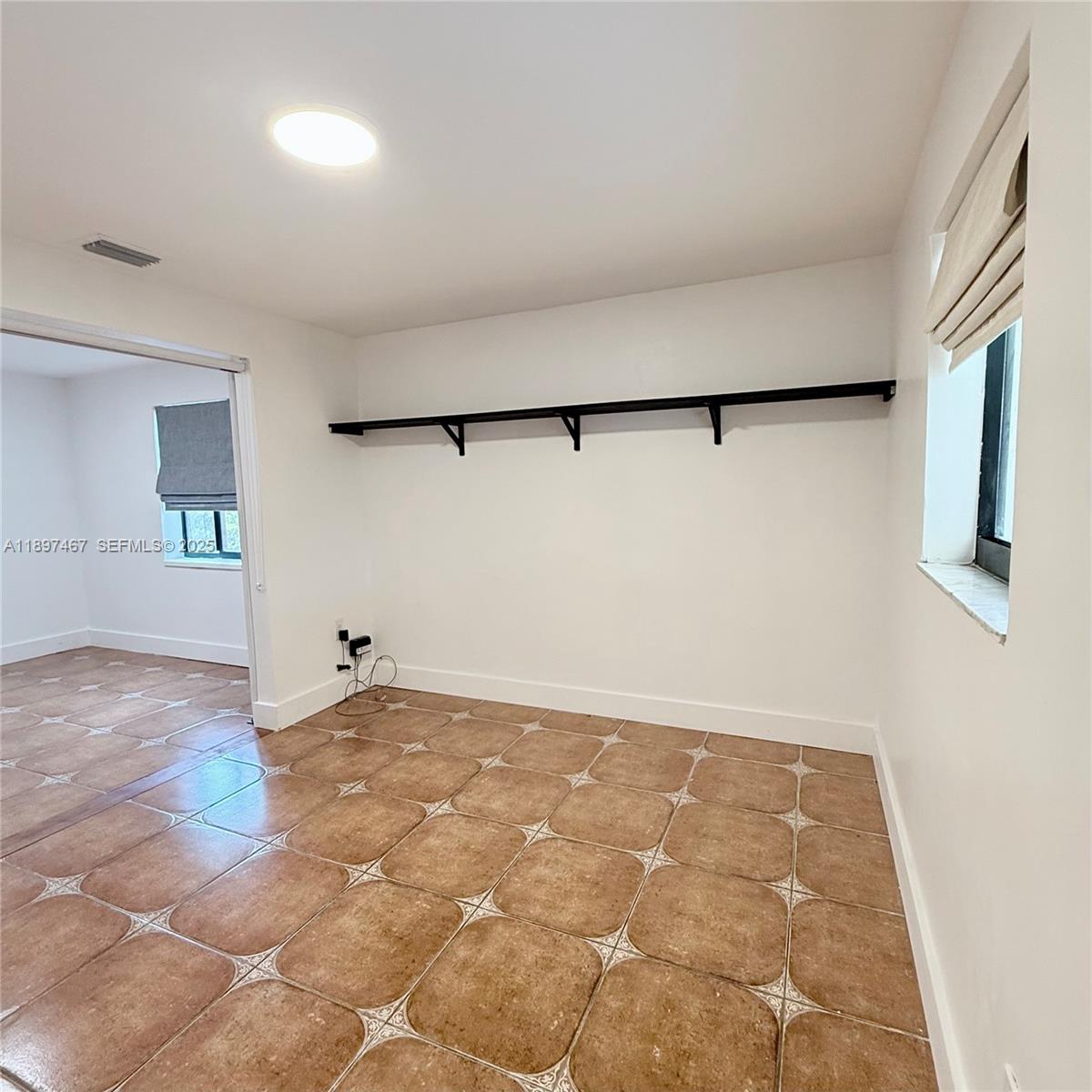 2729 Southwest 67th Avenue Miami, FL 33155 - Photo 11 of 39 a view of a big room with wooden floor and cabinet