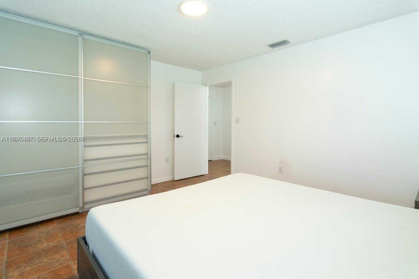 2729 Southwest 67th Avenue Miami, FL 33155 - Photo 22 of 39 a bedroom with a bed and a cabinets