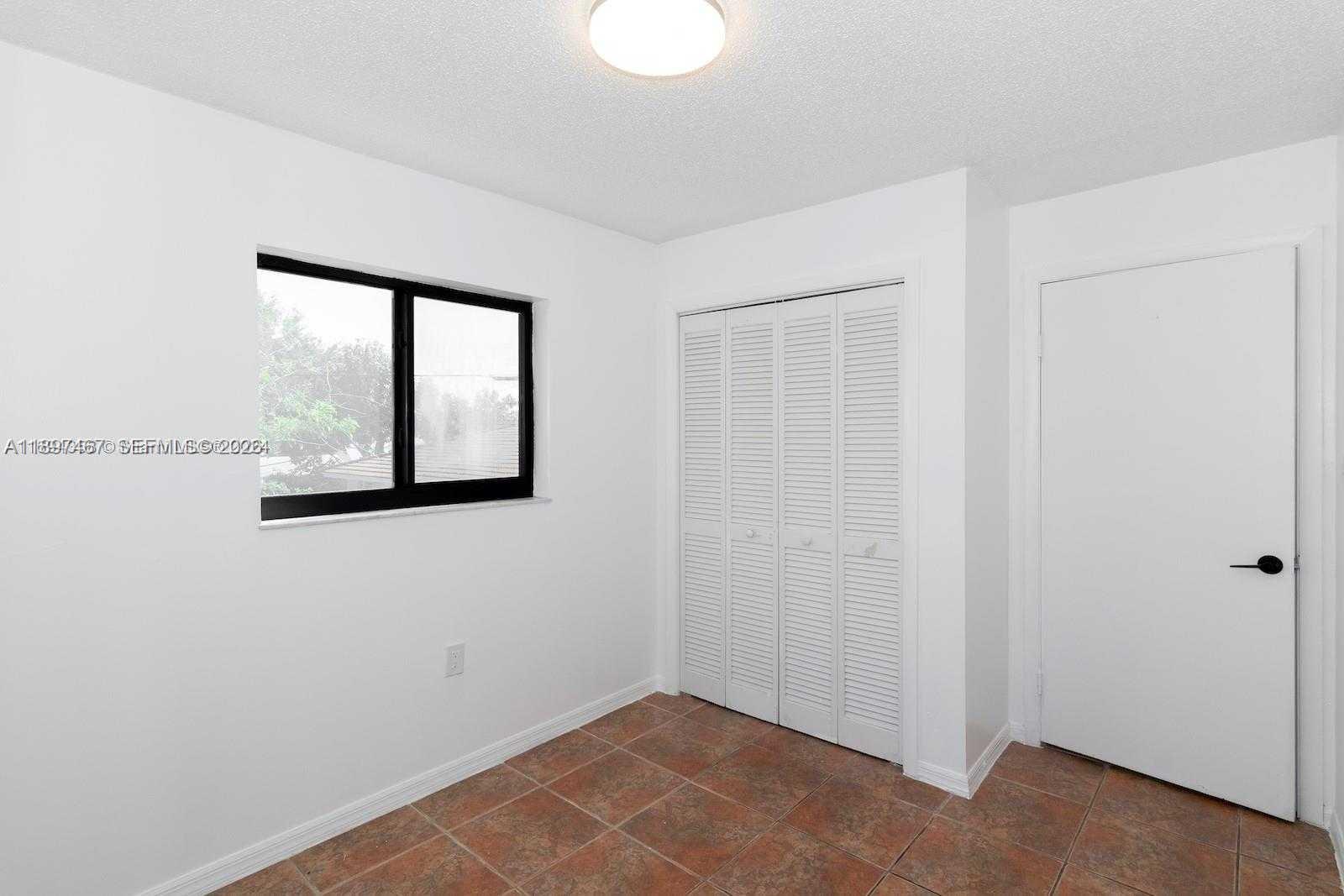 2729 Southwest 67th Avenue Miami, FL 33155 - Photo 24 of 39 a view of an empty room with windows