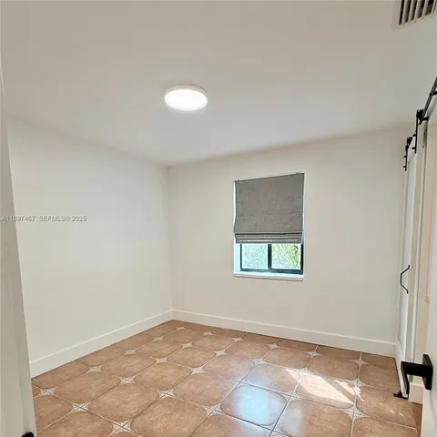 a kitchen with stainless steel appliances granite countertop a stove top oven a sink a counter space and cabinets