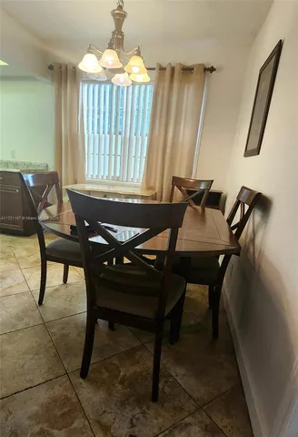 a view of a dining room with furniture and window