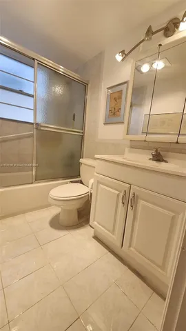 a bathroom with a toilet a sink and bathtub