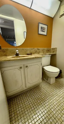 a bathroom with a toilet and a mirror