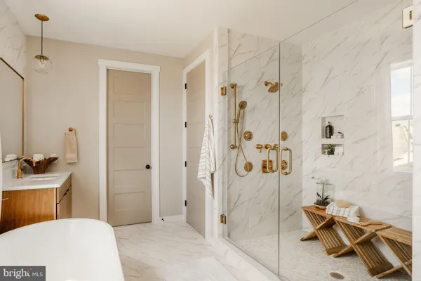 a bathroom with a sink a toilet a glass door shower and mirror