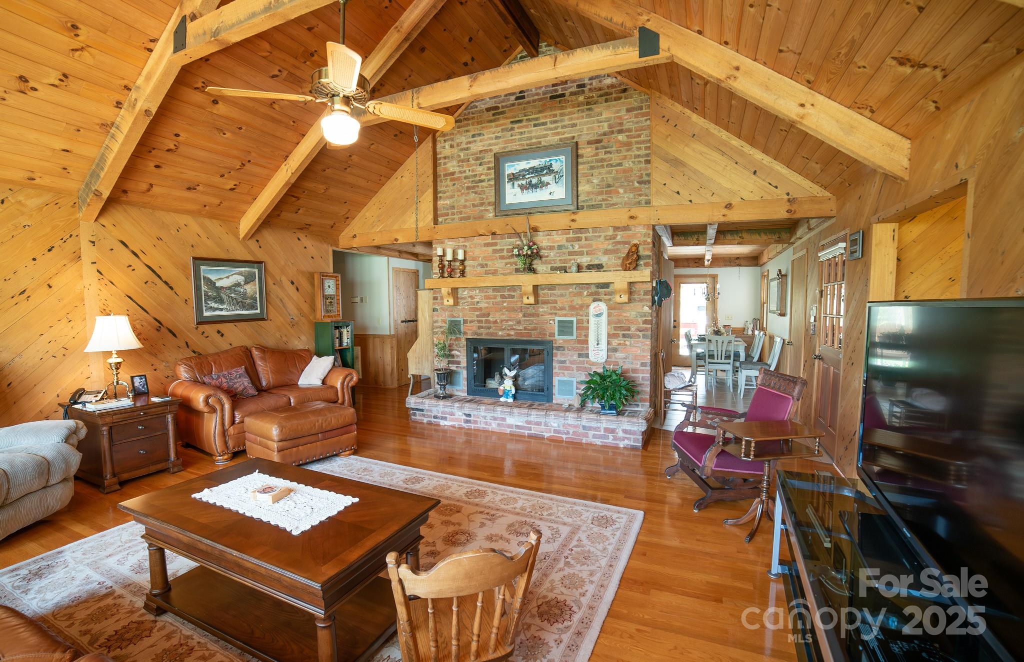 1368 Cajah Mountain Road Hudson, NC 28638 - Photo 11 of 36 a living room with furniture a fireplace and a flat screen tv