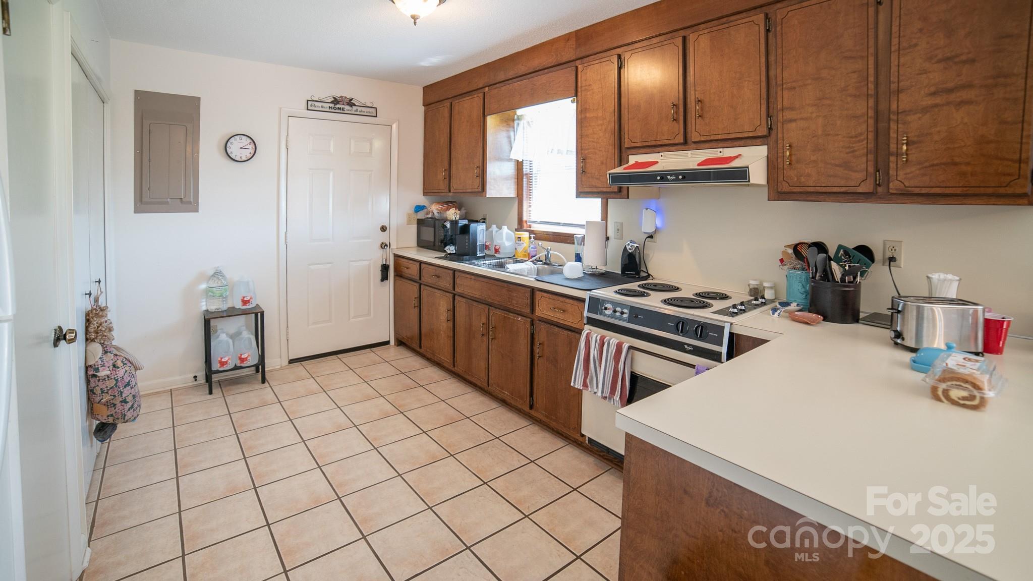 1368 Cajah Mountain Road Hudson, NC 28638 - Photo 27 of 36 a kitchen with a sink a stove and cabinets