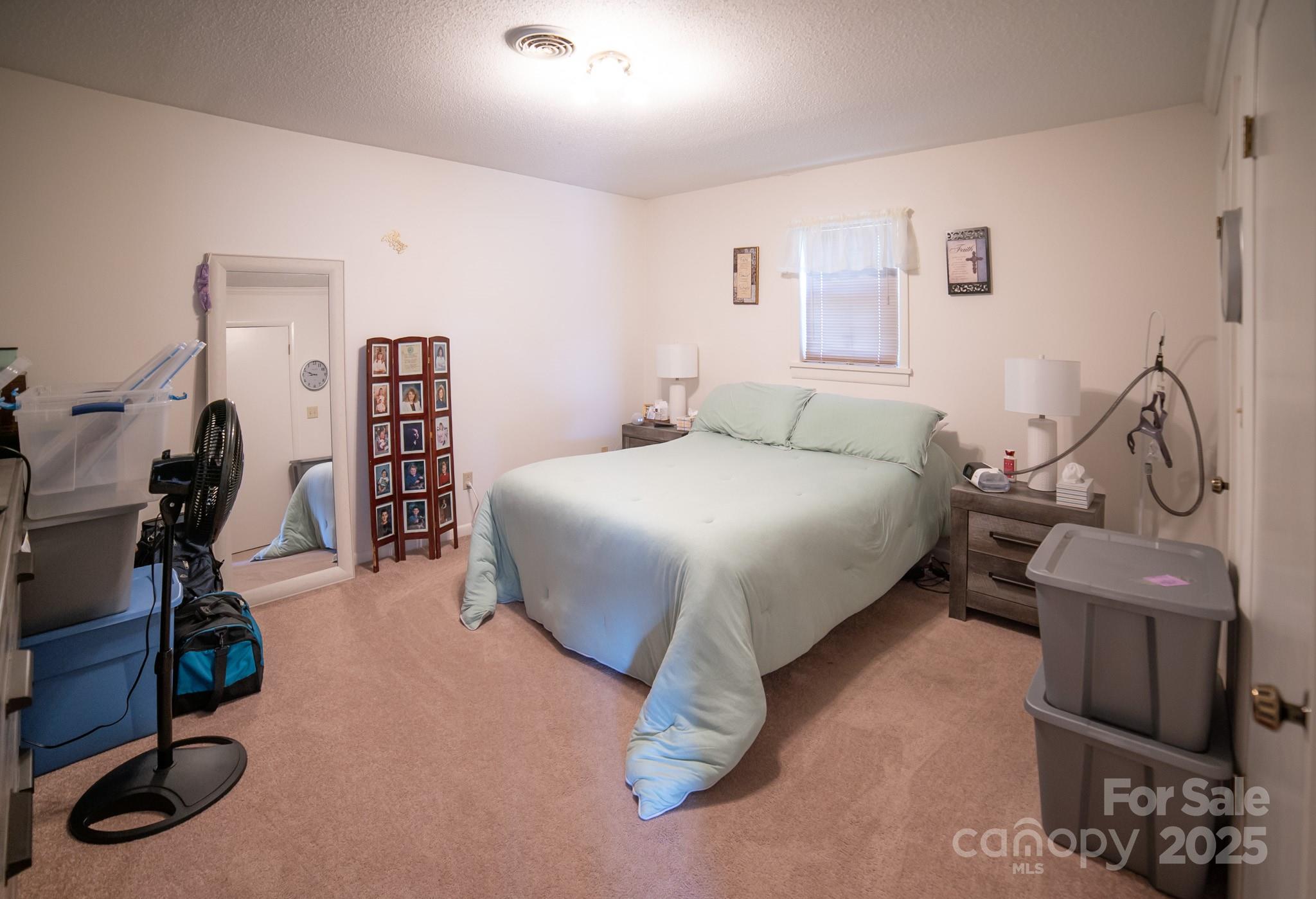 1368 Cajah Mountain Road Hudson, NC 28638 - Photo 29 of 36 a bedroom with a bed and gym equipment