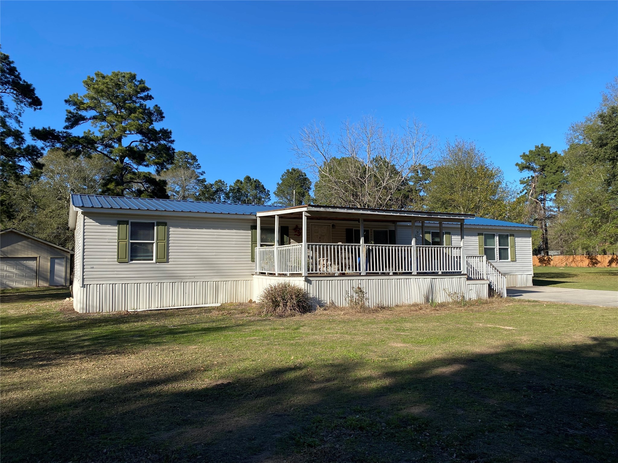 2581 Mann Road Conroe, TX 77303 - Photo 14 of 34 a front view of a house with a garden