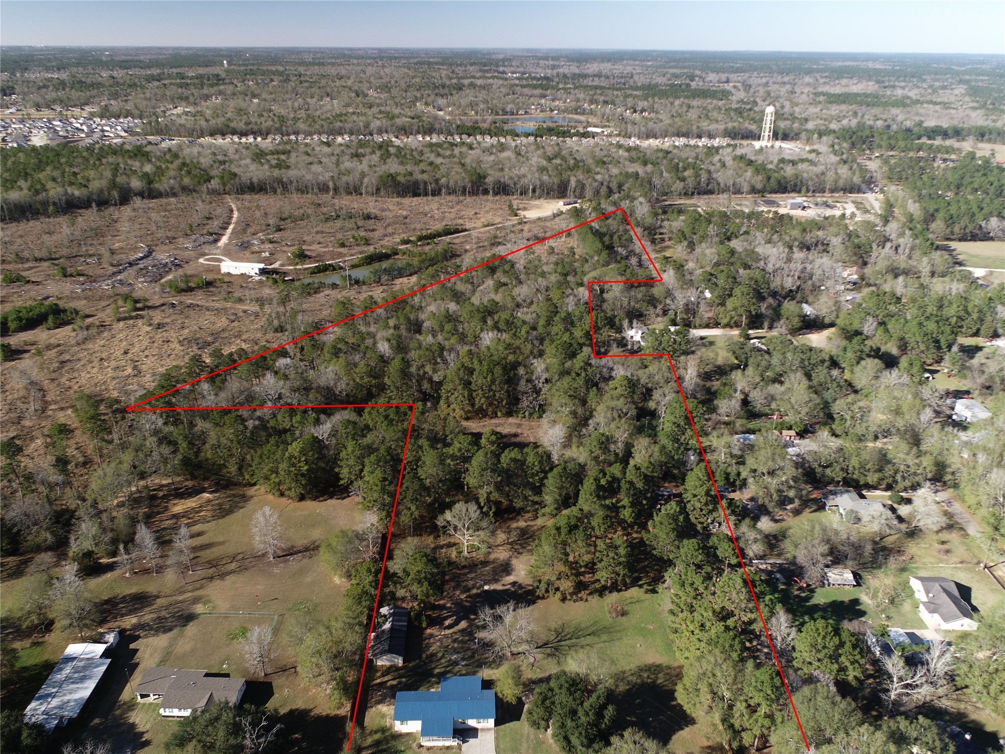 2581 Mann Road Conroe, TX 77303 - Photo 2 of 34 an aerial view of town with residential houses and trees
