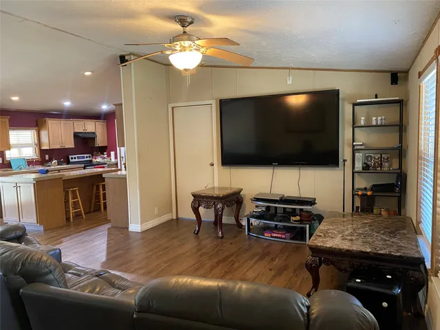 a kitchen with a table chairs refrigerator and a couch