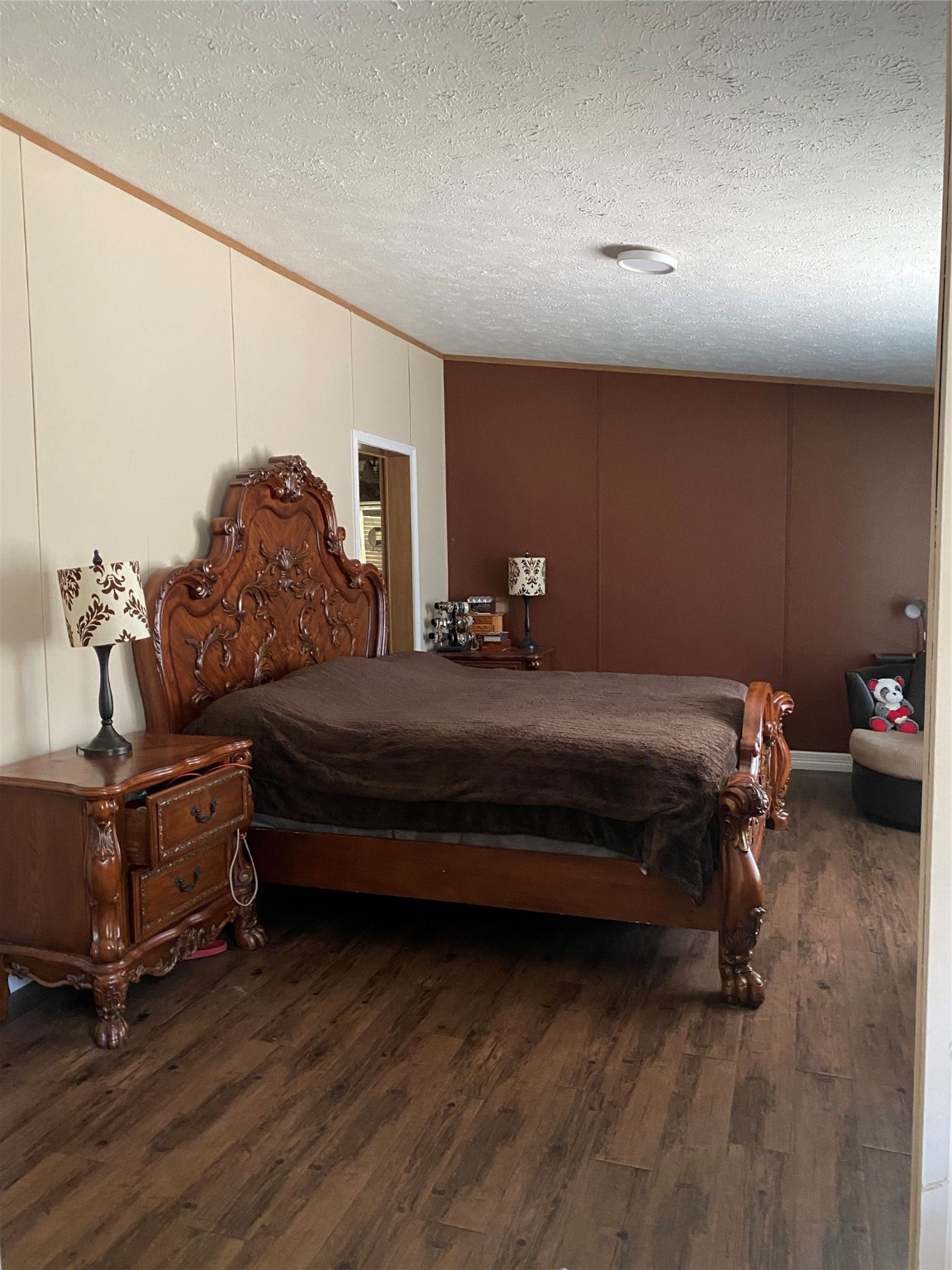 2581 Mann Road Conroe, TX 77303 - Photo 32 of 34 a bedroom with furniture and wooden floor