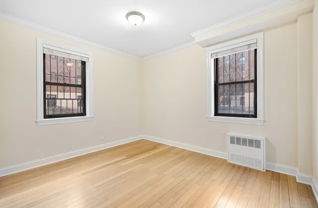 a bedroom with a large bed and a potted plant