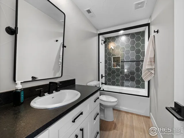 a bathroom with a sink a mirror and a toilet