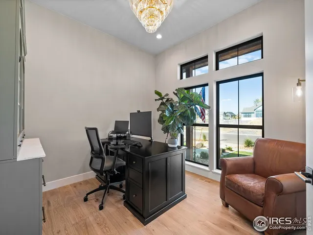 a living room with furniture fireplace and a large window