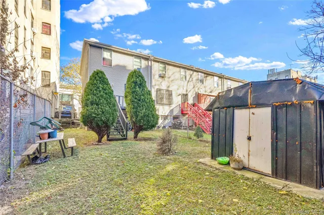 a view of backyard with wheel chair and potted plants
