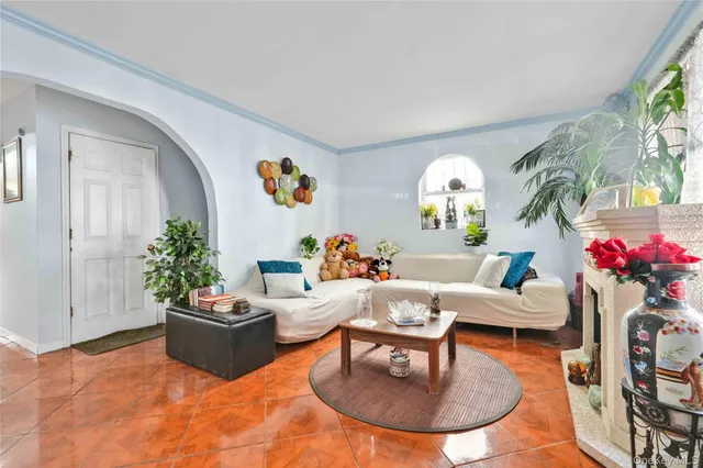 a living room with furniture fireplace and a potted plant