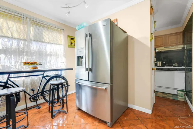 a kitchen with stainless steel appliances granite countertop a refrigerator and a stove top oven