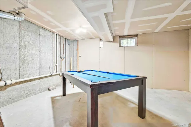 a room with pool table and windows
