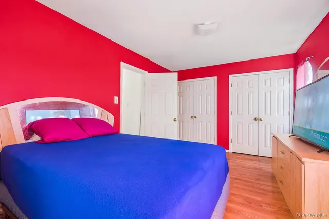 a room with a bed and a flat screen tv