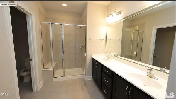 a bathroom with a double vanity sink and mirror