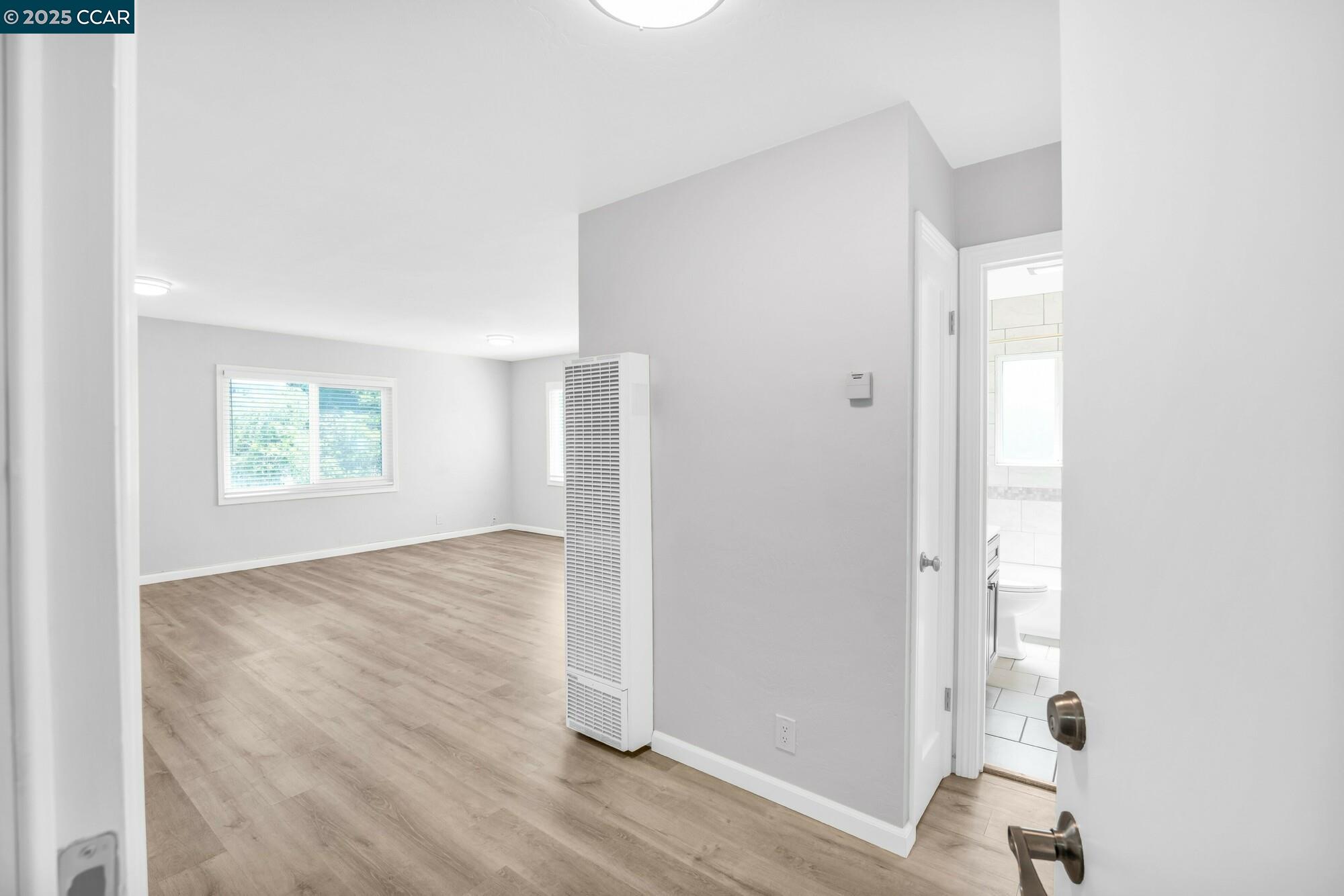 1919 Curtis Street Berkeley, CA 94702 - Photo 18 of 54 a view of an empty room with wooden floor and a window