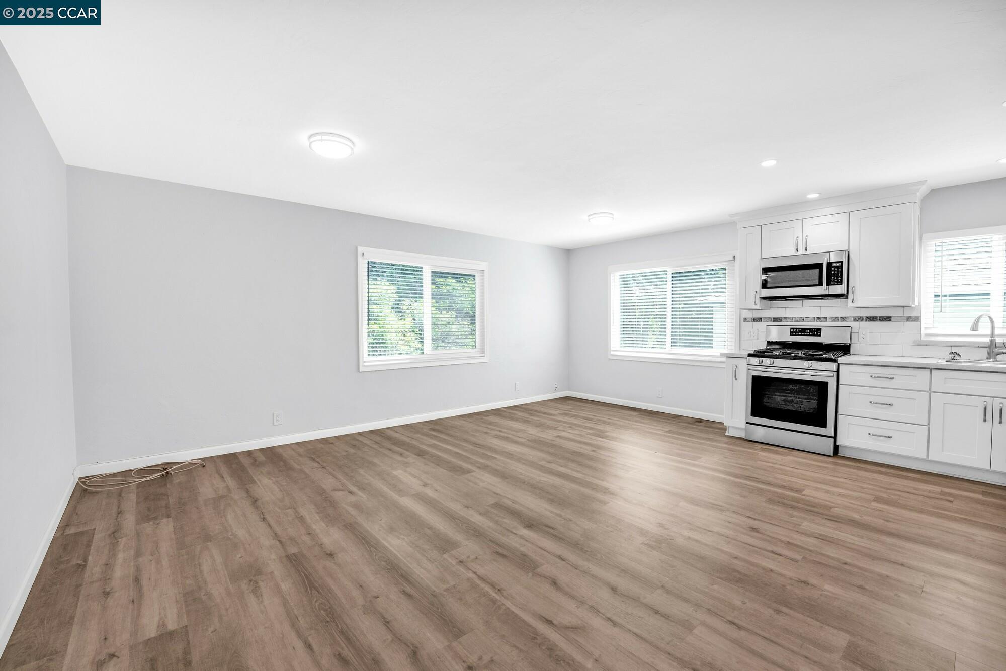 1919 Curtis Street Berkeley, CA 94702 - Photo 20 of 54 a view of a kitchen with microwave and stove top oven