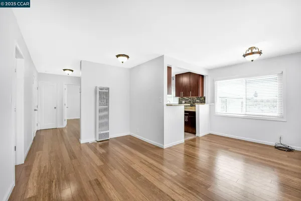 a view of a room with wooden floor and a window